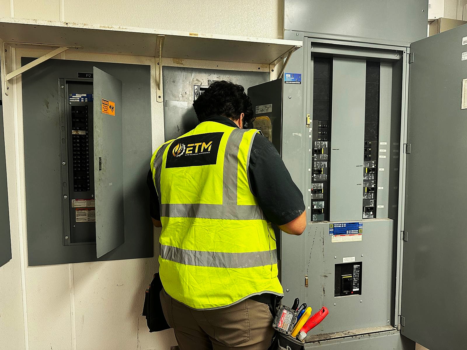 ETM technician inspecting commercial electrical panels