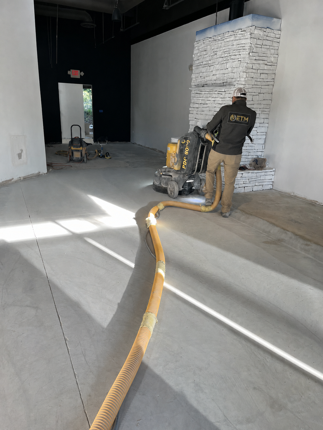ETM technician polishing flooring inside a commercial space