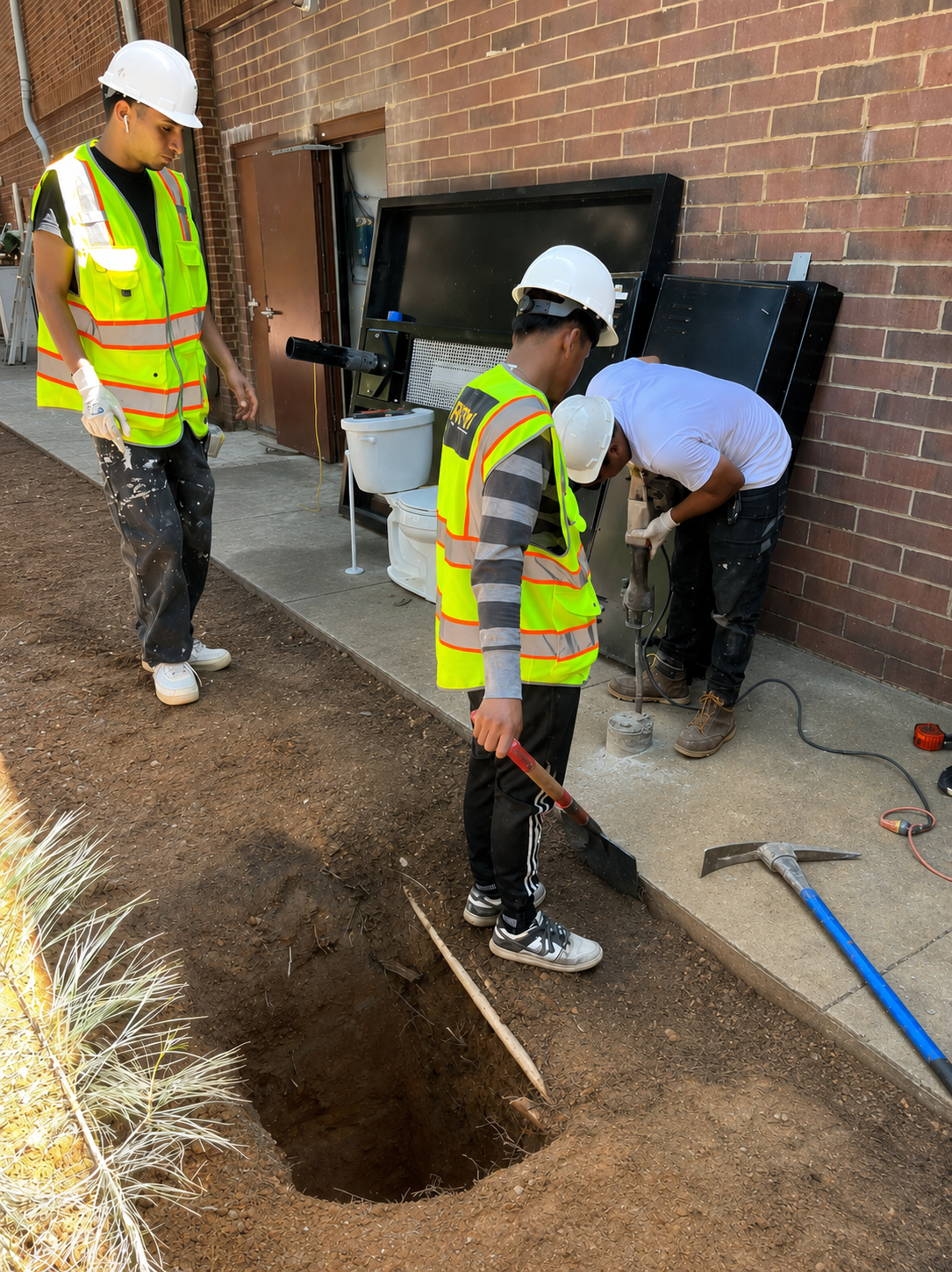 ETM crew performing exterior commercial maintenance